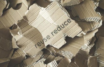 cardboard with 'reduce reuse' printed on it