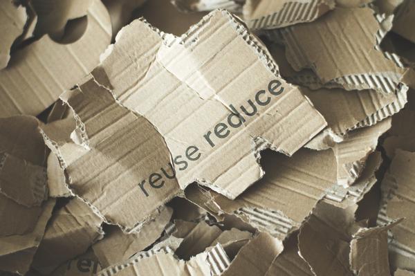 cardboard with 'reduce reuse' printed on it