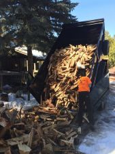dump truck dumping firewood